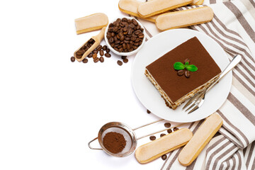 Traditional Italian Tiramisu dessert square portion on ceramic plate and savoiardi cookies isolated on white