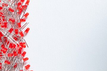 Lots of red LEDs in a white background with copy space. Electronic components.