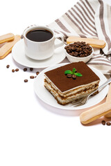 Traditional Italian Tiramisu dessert square portion on ceramic plate, savoiardi cookies and cup of fresh espresso coffee isolated on white