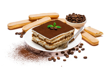 Traditional Italian Tiramisu dessert square portion on ceramic plate and savoiardi cookies isolated on white