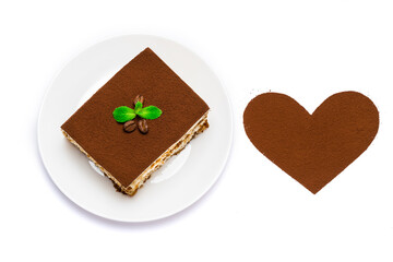 Traditional Italian Tiramisu square dessert portion on ceramic plate and heart shape made of cocoa powder isolated on white