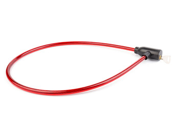 Flexible red bicycle cable with key on white background.  Security and safety concept.