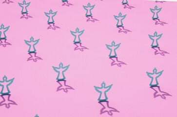 Grey contours of angels on pink surface