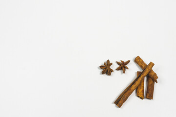 Christmas wishes white background with star anise and cinnamon and Christmas balls