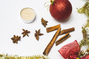 Christmas wishes white background with star anise and cinnamon and Christmas balls
