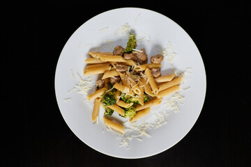 photography of a plate of macaroni with broccoli and sausages