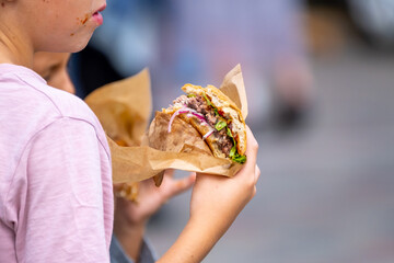 Anonymous child with delicious burger