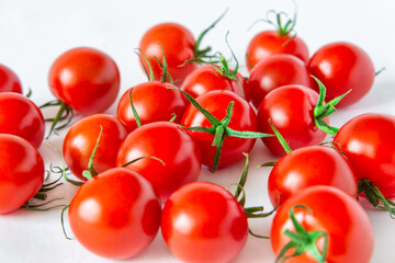 Fresh cherry tomatoes on white background,. Close-up foreground.