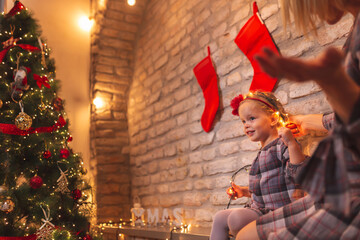 Mother and daughter decorating home for Christmas