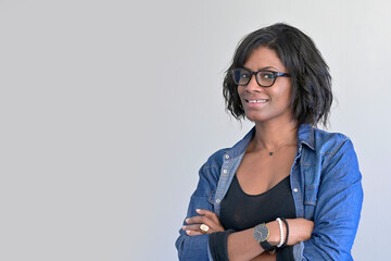 Portrait of african american woman wearing blue jeans and eyeglasses, isolated