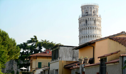 Unusual view of the tower of Pisa from a street of small houses that enjoy this wonderful view.