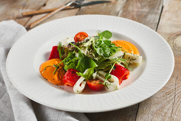 Roasted pepper salad with calamari and fresh greens