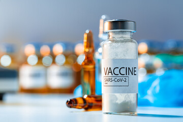 Vaccine vials of Sars-cov-2 on table in laboratory .