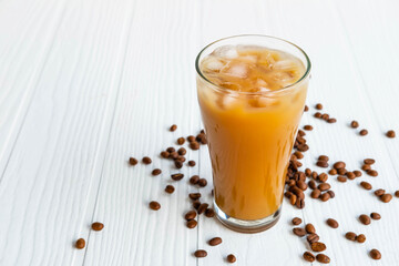 .Iced coffee in a glass On a white wooden background