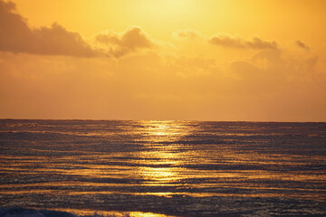 Fototapeta na wymiar Beautiful golden beach sunrise on the Mediterranean coast with sun reflection. Clouds. Golden hour.