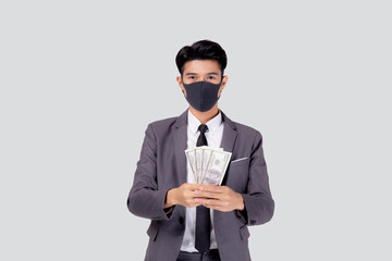 Young asian businessman in face mask holding money dollar isolated on white background, pandemic and crisis of economic, business man in medical mask and investment during disease covid-19.