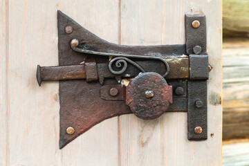 Fototapeta na wymiar Vintage iron lock of an old wooden door