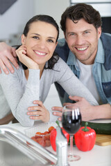 happy couple embracing in the kitchen