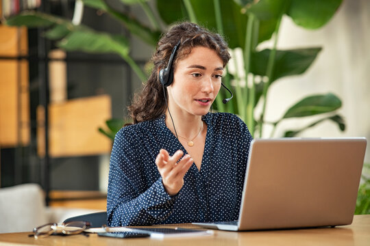 Young woman on video call using laptop at office