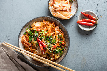 Asian food, wok noodle and vegetables in ceramic bowl, top view