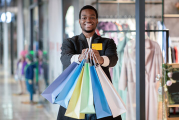 Credit card and a lot of purchases on black friday before holidays © Prostock-studio