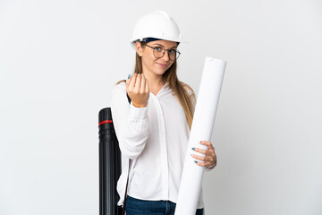 Young Lithuanian architect woman with helmet and holding blueprints isolated on white background inviting to come with hand. Happy that you came