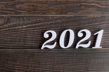 Happy New year 2021, Closeup the white letters 2021 and Italic on wooden background and copy space on left for input design and text, Starting of New year concept.