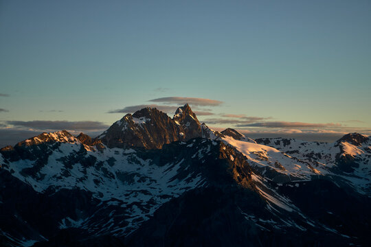 natural calm sunrise in the mountains with tranquil clouds over tall peaks above Arolla Valley in Switzerland
