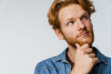 Thinking handsome ginger guy posing and looking upward