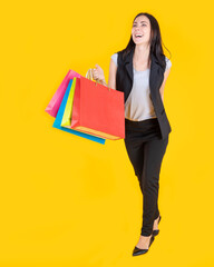 Young happy summer shopping woman with shopping bags. Happy beautiful shopaholic woman carrying...