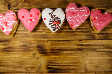 Heart shaped cookies on wooden table. Top view, copy space. Dessert for Valentine day