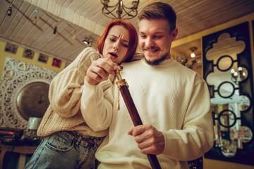 Having fun. Smiling family, caucasian couple looking for home decoration and holiday's gifts in household store. Stylish and retro things for greetings or design. Interior renovation, celebrating time