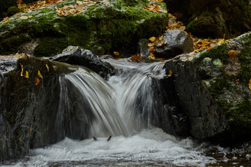 Small waterfalls in the bed of the Sestil de Maíllo stream. Autumn in the Sierra de Guadarrama National Park. Madrid's community. Spain