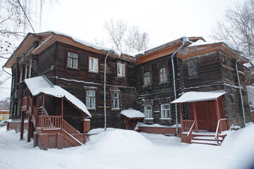 Russian snow winter. Carved windows, frames on vintage wooden house on Karl Marx Street, 27/1,...