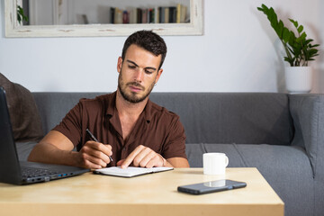 Handsome male working on laptop from home