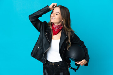 Romanian woman holding a motorcycle helmet isolated on blue background smiling a lot