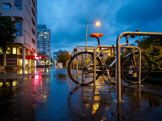 Fototapeta na wymiar a bicycle left on night rainy city street