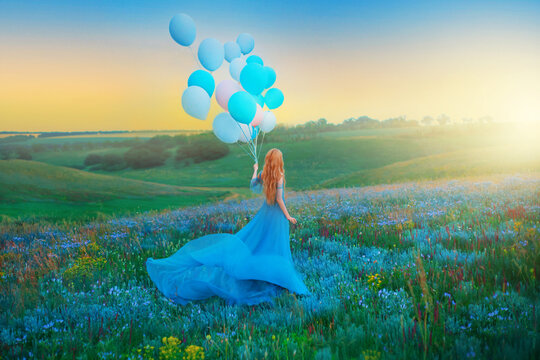 Silhouette happy woman. Fantasy girl princess holding in hand ball air balloon. long blue tulle dress fluttering fly in wind. Sunset sky fog, colorful flowers green meadow. blond red hair, back view