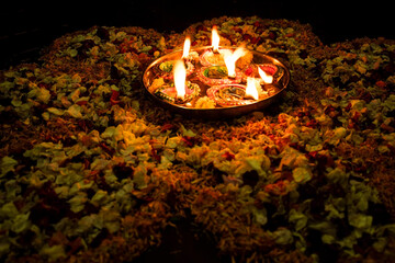 Floor decorated with diyas and flowers on the occasion of diwali