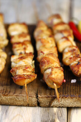 Appetizing chicken skewers on wooden sticks.
