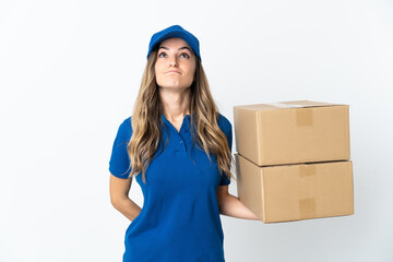 Young Romanian delivery woman isolates on white background and looking up