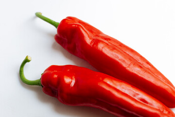 Fresh red pepper on white background.Two red sweet bell peppers on white background. 