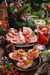 Christmas table with mini canapes and sliced ham and meats