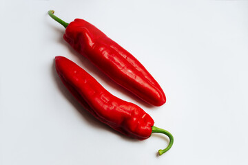 Fresh red pepper on white background.Two red sweet bell peppers on white background. 