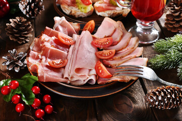 Christmas table with sliced ham and meats
