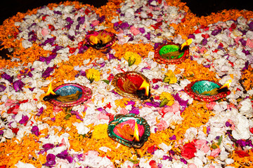Floor decorated with diyas and flowers on the occasion of diwali