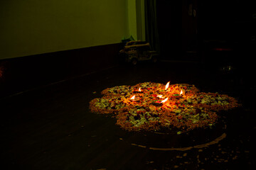 Floor decorated with diyas and flowers on the occasion of diwali