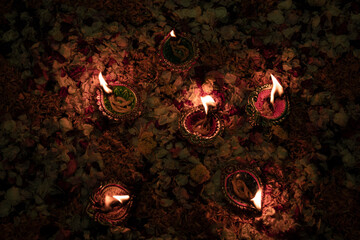 Floor decorated with diyas and flowers on the occasion of diwali