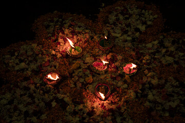 Floor decorated with diyas and flowers on the occasion of diwali