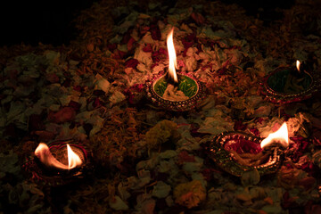Floor decorated with diyas and flowers on the occasion of diwali